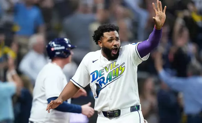 Tampa Bay Rays' Junior Caminero celebrates after scoring against the Cleveland Guardians during the fourth inning in Game 2 of an American League Championship Series baseball game in St. Petersburg, Fla. Tuesday, Oct. 13, 2026. (AP Photo/David J. Phillip)