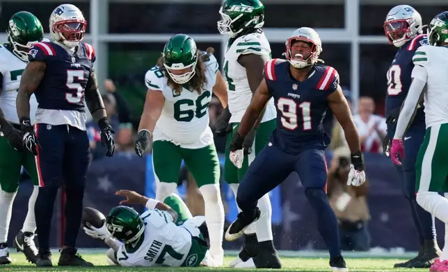 New England Patriots linebacker Elijah Ponder (91) celebrates after sacking New York Jets quarterback Geno Smith (7) during the second half of an NFL football game in Foxborough, Mass., Sunday, Oct. 18, 2026. (AP Photo/Charles Krupa)