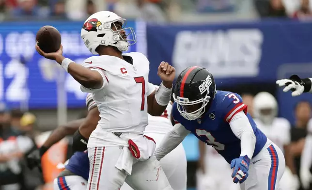 Arizona Cardinals quarterback Jacoby Brissett (7) throws as he his hit by New York Giants linebacker Abdul Carter (3) during an NFL football game, in East Rutherford, N.J., Sunday, Oct. 4, 2026. (AP Photo/Adam Hunger)