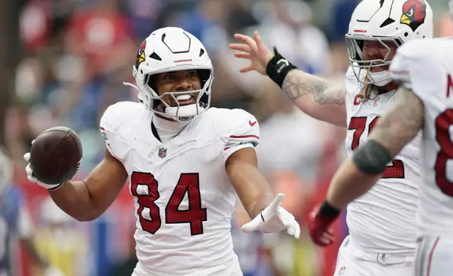 Arizona Cardinals tight end Elijah Higgins (84) celebrates a touchdown catch against the New York Giants with Cardinals center Hjalte Froholdt, right, during an NFL football game, in East Rutherford, N.J., Sunday, Oct. 4, 2026. (AP Photo/Adam Hunger)