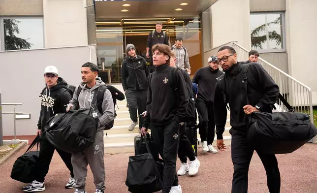 New Orleans Saints teammates arrive at the reception pavilion of Charles de Gaulle airport in Roissy north of Paris, Monday, Oct. 19, 2026. (AP Photo/Teresa Suarez)