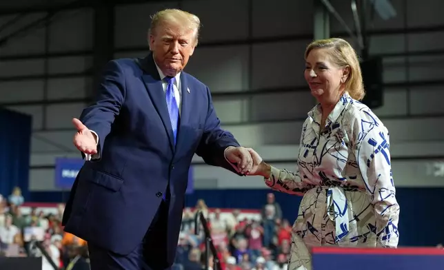 President Donald Trump, left, escorts Sen. Darline Graham, R-S.C., off the stage after Graham spoke during a campaign rally at Rock Hill Sports and Event Center, Thursday, Oct. 29, 2026, in Rock Hill, S.C. (AP Photo/Alex Brandon)