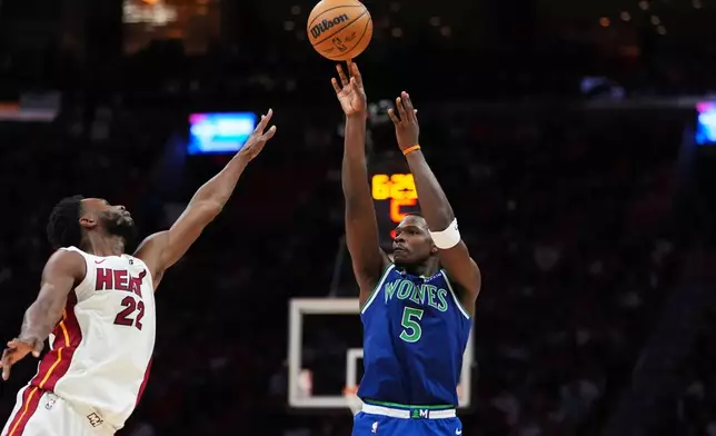 Minnesota Timberwolves guard Anthony Edwards (5) shoots past Miami Heat forward Andrew Wiggins (22) during the second half of an NBA basketball game, Wednesday, Oct. 21, 2026, in Miami. (AP Photo/Rebecca Blackwell)
