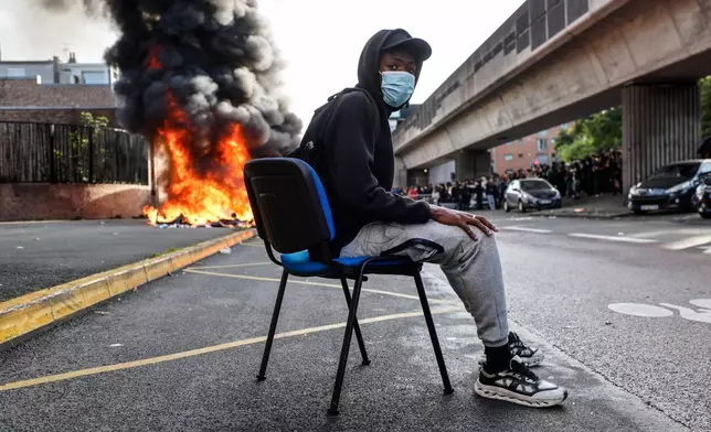 Students burn garbage as they protest to demand more resources for school, in Lille, France, Thursday, Oct. 1, 2026. (AP Photo/Jean-Francois Badias)