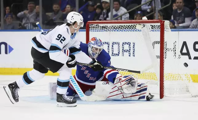 New York Rangers goaltender Igor Shesterkin, right, makes a save against a shot-attempt by Utah Mammoth center Logan Cooley (92) during the second period of an NHL hockey game, Sunday, Oct. 4, 2026, in New York. (AP Photo/Heather Khalifa)