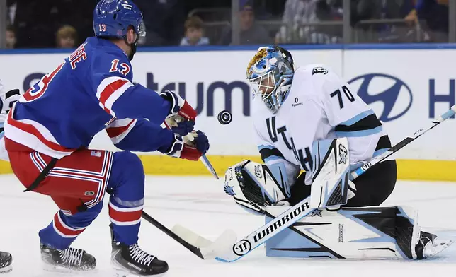 Utah Mammoth goaltender Karel Vejmelka (70) blocks a shot-attempt by New York Rangers' Alexis Lafrenière (13) during the first period of an NHL hockey game, Sunday, Oct. 4, 2026, in New York. (AP Photo/Heather Khalifa)