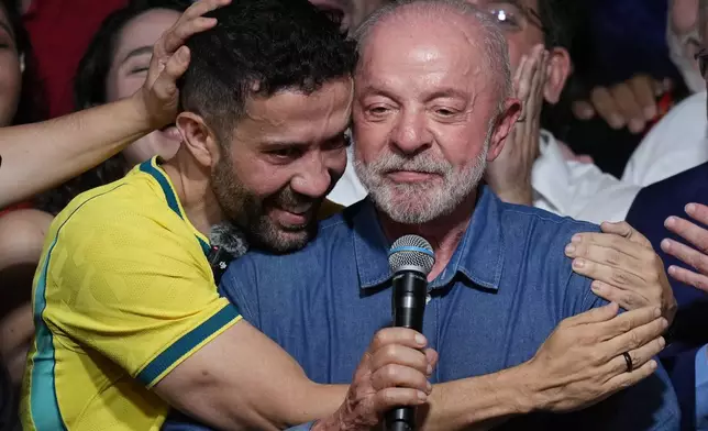 Brazilian lawmaker Andre Janones embraces President Luiz Inacio Lula da Silva as he delivers a victory speech after winning a fourth term in the presidential runoff in , Brazil, Sunday, Oct. 25, 2026.(AP Photo/Andre Penner)