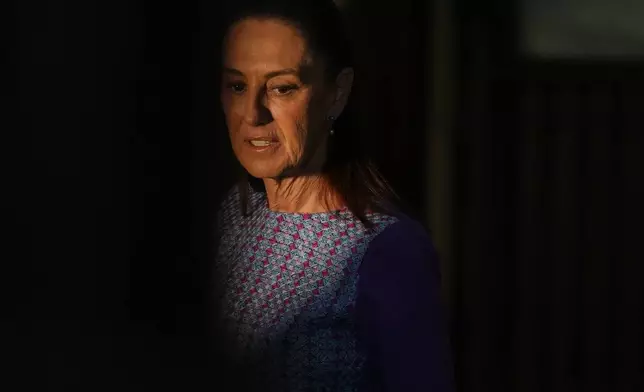 FILE - Mexican President Claudia Sheinbaum arrives at the National Palace to give her daily morning press conference in Mexico City, April 30, 2026. (AP Photo/Fernando Llano, File)