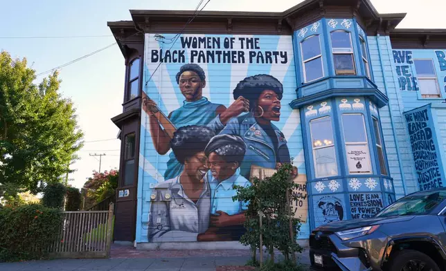 A mural commemorating the women of the Black Panther Party is painted on the side of a house in Oakland, Calif., on Tuesday, Oct. 13, 2026. (AP Photo/Terry Chea)