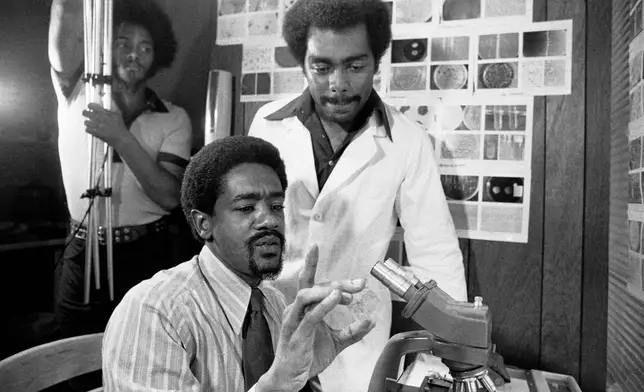 FILE - Bobby Seale, seated, is seen at the Black free health clinic on Sept. 8, 1972, in Berkeley, Calif. (AP Photo, File)