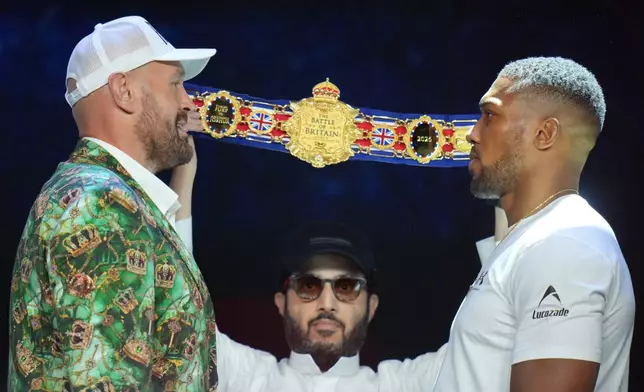 Tyson Fury, left, and Anthony Joshua, right, face off after a Press Conference in London, Wednesday, Sept. 30, 2026, to promote their upcoming fight which will take place at the Principality Stadium in Cardiff on Dec.11.(AP Photo/Kin Cheung)