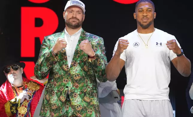 Tyson Fury, left, and Anthony Joshua, right, pose together after a Press Conference in London, Wednesday, Sept. 30, 2026, to promote their upcoming fight which will take place at the Principality Stadium in Cardiff on Dec.11.(AP Photo/Kin Cheung)