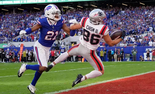 New England Patriots wide receiver Efton Chism III (86) makes a catch to score a touchdown against Buffalo Bills cornerback Davison Igbinosun (21) in the second half during an NFL football game in Orchard Park, N.Y., Sunday, Oct. 4, 2026. (AP Photo/Carolyn Kaster)