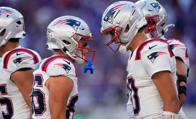 New England Patriots wide receiver Efton Chism III (86) celebrates with quarterback Drake Maye (10) after scoring a touchdown against the Buffalo Bills in the second half during an NFL football game in Orchard Park, N.Y., Sunday, Oct. 4, 2026. (AP Photo/Carolyn Kaster)