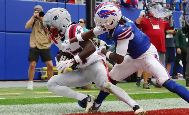 New England Patriots wide receiver Romeo Doubs (87) scores a touchdown against Buffalo Bills cornerback Maxwell Hairston (1) in the second half during an NFL football game in Orchard Park, N.Y., Sunday, Oct. 4, 2026. (AP Photo/Jeffrey T. Barnes)