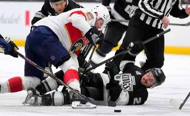 Florida Panthers center Sam Bennett, left, and Los Angeles Kings center Scott Laughton battle for the puck during the second period of an NHL hockey game Tuesday, Oct. 6, 2026, in Los Angeles. (AP Photo/Mark J. Terrill)