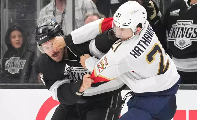 Los Angeles Kings defenseman Joel Edmundson, left, and Florida Panthers right wing Garnet Hathaway fight during the second period of an NHL hockey game Tuesday, Oct. 6, 2026, in Los Angeles. (AP Photo/Mark J. Terrill)