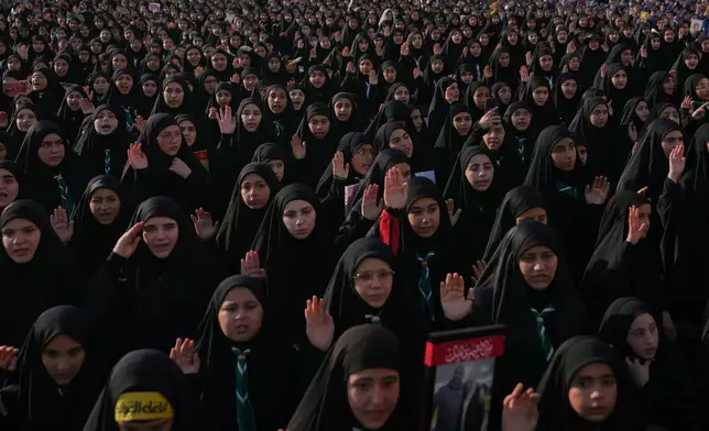 Members of Hezbollah's al-Mahdi Scouts raise their hands during a gathering marking the second anniversary of the assassinations of Hezbollah leaders Hassan Nasrallah and his cousin and successor, Hashem Safieddine, who were killed in Israeli airstrikes, in Dahiyeh, a southern suburb of Beirut, Lebanon, Sunday, Oct. 4, 2026. (AP Photo/Hassan Ammar)