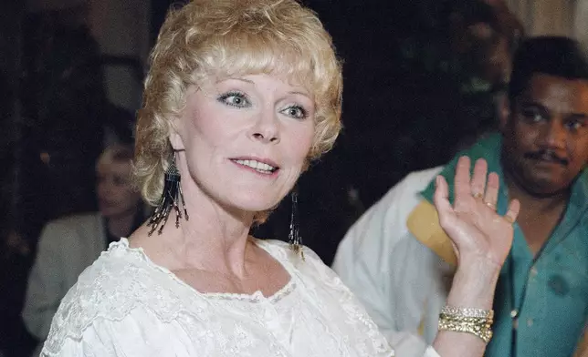 FILE - Elke Sommer gestures while answering reporters questions at her home in Beverly Hills, Calif., on Dec. 10, 1993. (AP Photo/Barbara Witz, File)