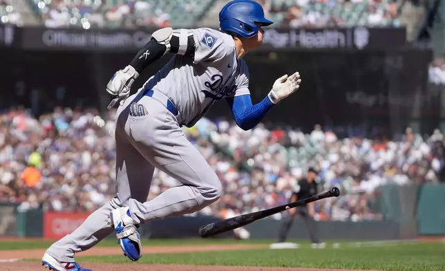 Los Angeles Dodgers designated hitter Shohei Ohtani runs to first base after hitting a single during the fifth inning of a baseball game against the San Francisco Giants, Saturday, Sept. 26, 2026, in San Francisco. (AP Photo/Jeff Chiu)