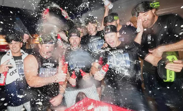 The New York Yankees, including relief pitcher David Bednar, third from left, celebrate after winning baseball's American League Wild Card Series against the Boston Red Sox in Game 2, Wednesday, Sept. 30, 2026, in New York. (AP Photo/Frank Franklin II)