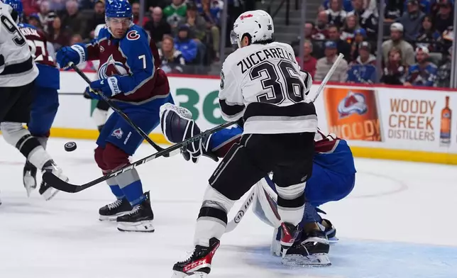 Los Angeles Kings right wing Mats Zuccarello, front right, swings at the puck as Colorado Avalanche goaltender Mackenzie Blackwood, back right, and Colorado Avalanche defenseman Devon Toews cover in the second period of an NHL hockey game Wednesday, Sept. 30, 2026, in Denver. (AP Photo/David Zalubowski)