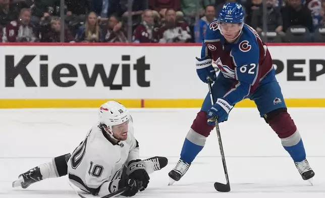 Los Angeles Kings left wing Artemi Panarin, left, tries to pass the puck as Colorado Avalanche left wing Artturi Lehkonen defends in the second period of an NHL hockey game Wednesday, Sept. 30, 2026, in Denver. (AP Photo/David Zalubowski)