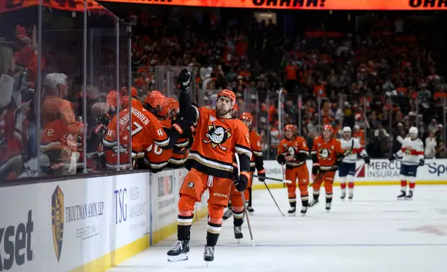 Anaheim Ducks left wing Cutter Gauthier (61) celebrates his goal with the bench during the first period of an NHL hockey game against the Florida Panthers, Sunday, Oct. 4, 2026, in Anaheim, Calif. (AP Photo/Kyusung Gong)
