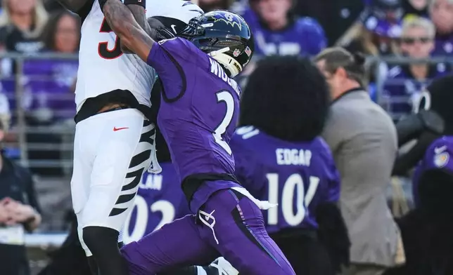Cincinnati Bengals wide receiver Tee Higgins (5) catches a pass as Baltimore Ravens cornerback Nate Wiggins (2) defends during the second half of an NFL football game in Baltimore, Sunday, Oct. 25, 2026. (AP Photo/Stephanie Scarbrough)
