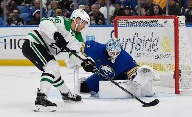 Dallas Stars right wing Mikko Rantanen, left, skates the puck in against Buffalo Sabres goalie Ukko-Pekka Luukkonen, right, during the second period of an NHL hockey game Thursday, Oct. 8, 2026, in Buffalo, N.Y. (AP Photo/Adrian Kraus)