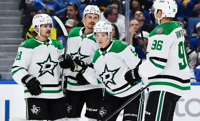 Dallas Stars center Sam Steel, left, celebrates with center Roope Hintz, second from left, defenseman Nils Lundkvist (5) and right wing Mikko Rantanen (96) after scoring during the second period of an NHL hockey game against the Buffalo Sabres, Thursday, Oct. 8, 2026, in Buffalo, N.Y. (AP Photo/Adrian Kraus)