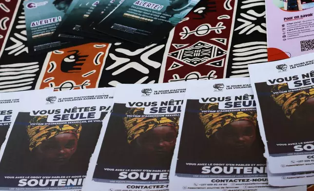 Information pamphlets distributed by the organization Sourires de Femmes are displayed during a sit-in campaign against women killing in Yaoundé, Cameroon, Friday, Sept, 18, 2026 (AP Photo/Angel Ngwe)