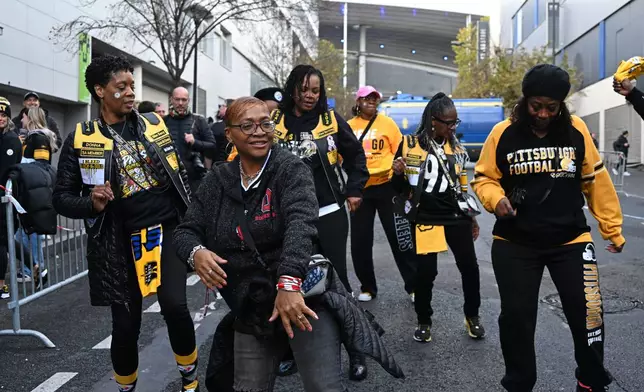 Supporters of the Pittsburgh Steelers wait outside the Stade de France stadium before the start of the NFL football game between Pittsburgh Steelers and New Orleans Saints in Saint-Denis, outside Paris, Sunday, Oct. 25, 2026. (AP Photo/Emma Da Silva)