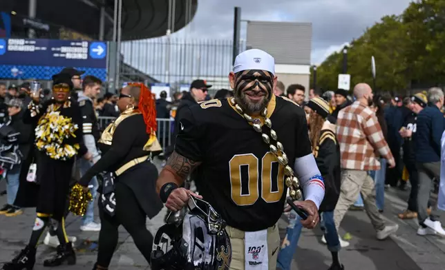 A supporter of the New Orleans Saints arrives to the Stade de France stadium before the start of the NFL football game between Pittsburgh Steelers and New Orleans Saints in Saint-Denis, outside Paris, Sunday, Oct. 25, 2026. (AP Photo/Emma Da Silva)
