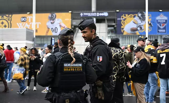 Police officers patrol outside the Stade de France stadium before the start of the NFL football game between Pittsburgh Steelers and New Orleans Saints in Saint-Denis, outside Paris, Sunday, Oct. 25, 2026. (AP Photo/Emma Da Silva)