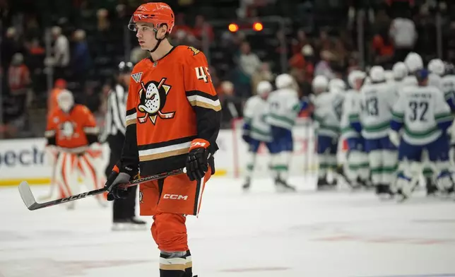 Anaheim Ducks right wing Beckett Sennecke skates off the ice after a goal by Vancouver Canucks defenseman Filip Hronek in overtime of an NHL hockey game Tuesday, Oct. 27, 2026, in Anaheim, Calif. (AP Photo/Gregory Bull)