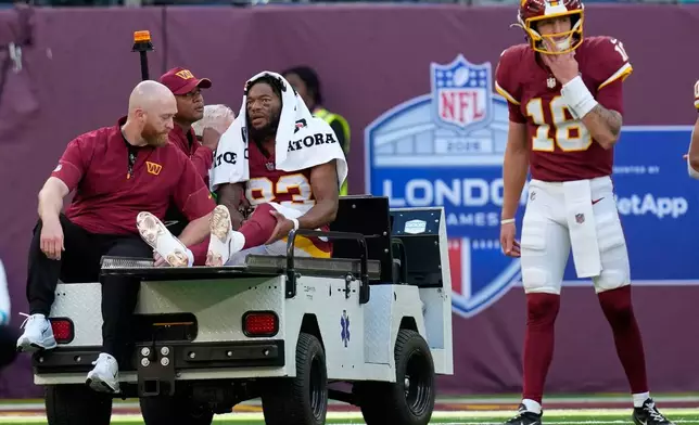 Washington Commanders wide receiver Jaylin Lane (83) is taken from the field injured during an NFL football game against Indianapolis Colts in London, Sunday, Oct. 4, 2026. (AP Photo/David J. Phillip)
