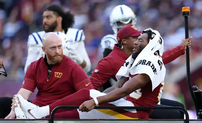 Washington Commanders wide receiver Jaylin Lane (83) is taken from the field injured during an NFL football game against Indianapolis Colts in London, Sunday, Oct. 4, 2026. (AP Photo/Ian Walton)