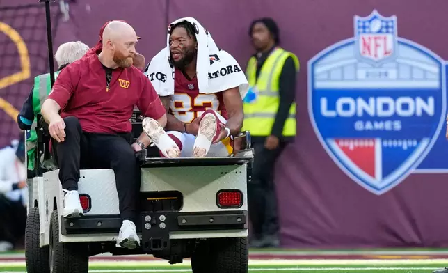 Washington Commanders wide receiver Jaylin Lane (83) is taken from the field injured during an NFL football game against Indianapolis Colts in London, Sunday, Oct. 4, 2026. (AP Photo/David J. Phillip)