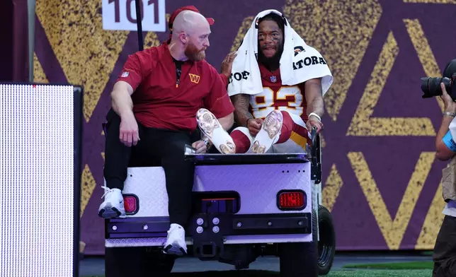 Washington Commanders wide receiver Jaylin Lane (83) is taken from the field injured during an NFL football game against Indianapolis Colts in London, Sunday, Oct. 4, 2026. (AP Photo/Ian Walton)