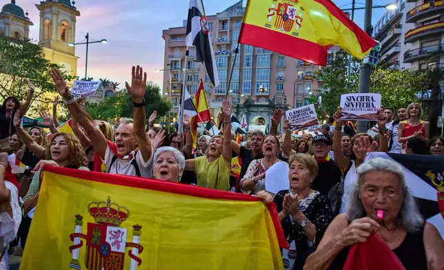 Local residents protest the Spanish government's handling of the Ceuta border crisis, two months after it occurred, in the Spanish enclave of Ceuta, Wednesday, Sept. 30, 2026. (AP Photo/Bernat Armangue)