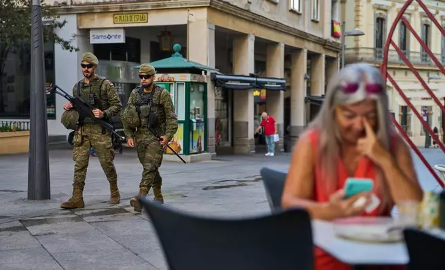 Spanish soldiers patrol downtown Ceuta on Thursday, Oct. 1, 2026. (AP Photo/Bernat Armangue)