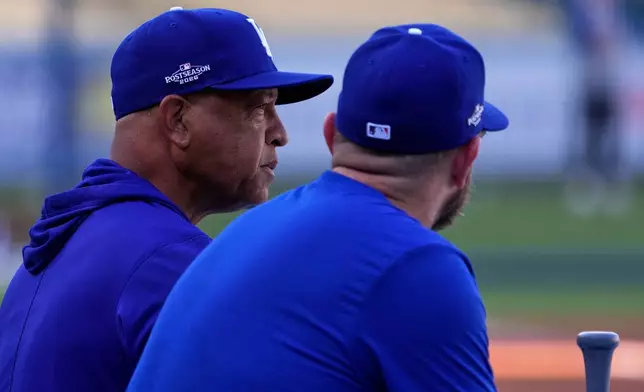 Los Angeles Dodgers manager Dave Roberts, left, talks with third baseman Max Muncy during practice ahead of a baseball NL Division Series Thursday, Oct. 1, 2026, in Los Angeles. (AP Photo/Mark J. Terrill)