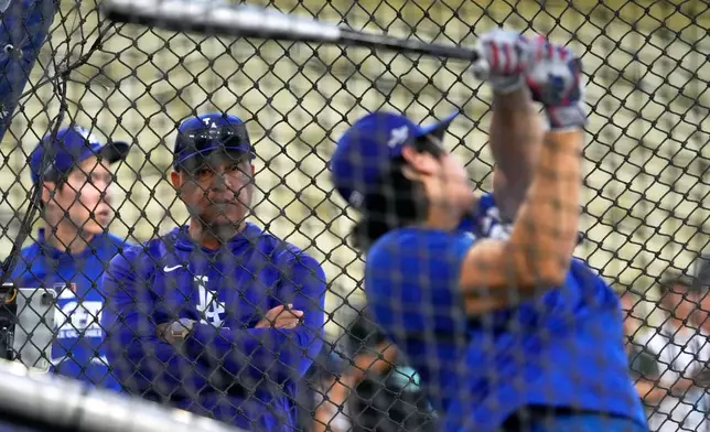 Los Angeles Dodgers manager Dave Roberts, center, watches as Shohei Ohtani hits during practice ahead of a baseball NL Division Series Friday, Oct. 2, 2026, in Los Angeles. (AP Photo/Mark J. Terrill)