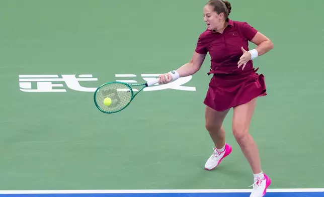Jelena Ostapenko of Latvia returns the ball against Sonay Kartal of Britain in a women's singles semifinal match during the 2026 Wuhan Open tennis tournament in Wuhan in central China's Hubei Province on Saturday, Oct. 17, 2026. (Chinatopix Via AP)
