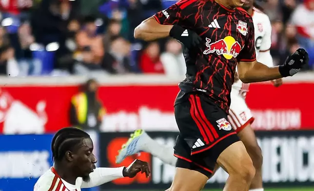 Toronto FC defender Nickseon Gomis, left, fights for the ball against New York Red Bulls midfielder Adri Mehmeti, front right, during an MLS soccer match Saturday, Oct. 17, 2026, in Harrison, N.J. (AP Photo/Eduardo Munoz Alvarez)