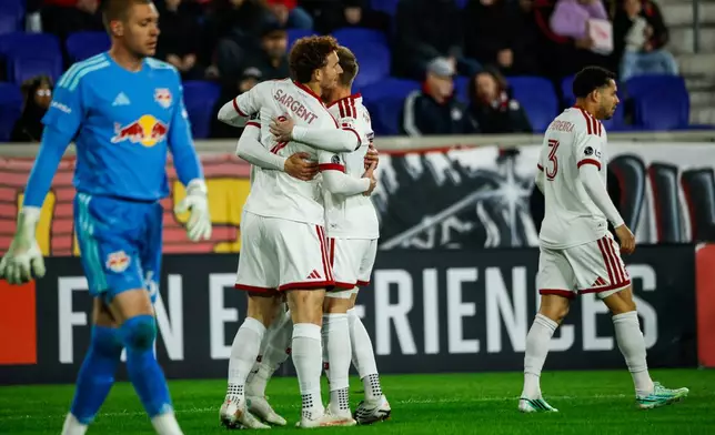 Toronto FC players celebrate after a goal against the New York Red Bulls during an MLS soccer match Saturday, Oct. 17, 2026, in Harrison, N.J. (AP Photo/Eduardo Munoz Alvarez)