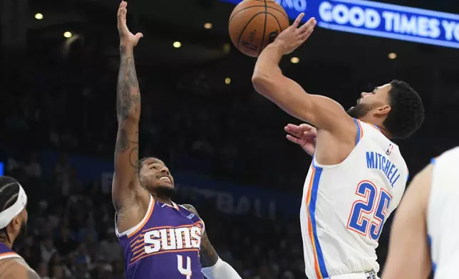 Oklahoma City Thunder guard Ajay Mitchell (25) shoots over Phoenix Suns guard Jalen Green (4) during the second half of an NBA basketball game, Monday, Oct. 26, 2026, in Oklahoma City. (AP Photo/Kyle Phillips)