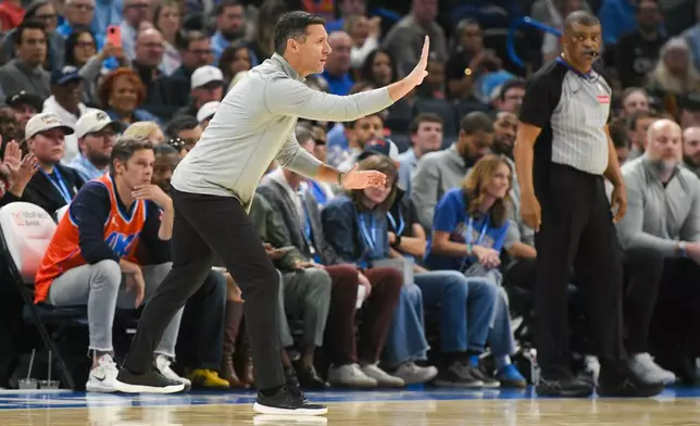 Oklahoma City Thunder head coach Mark Daigneault, front left, gives instruction during the first half of an NBA basketball game against the Phoenix Suns, Monday, Oct. 26, 2026, in Oklahoma City. (AP Photo/Kyle Phillips)