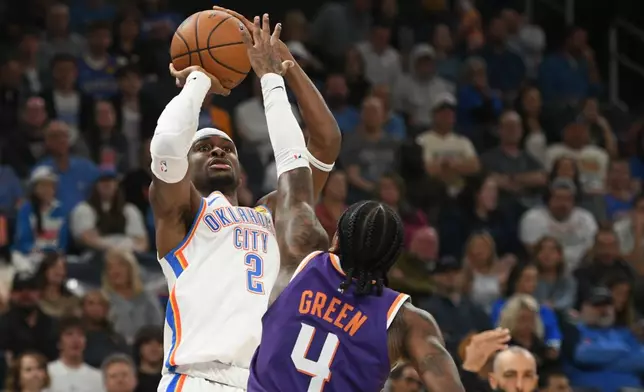 Oklahoma City Thunder guard Shai Gilgeous-Alexander (2) looks to shoot over Phoenix Suns guard Jalen Green (4) during the second half of an NBA basketball game, Monday, Oct. 26, 2026, in Oklahoma City. (AP Photo/Kyle Phillips)
